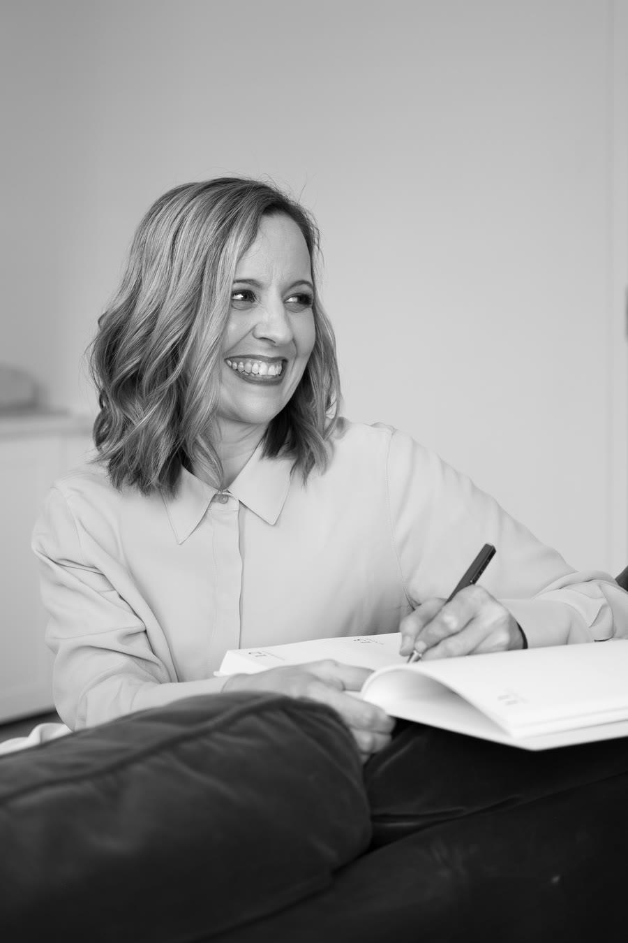 Sharon Crombie writing in a notebook